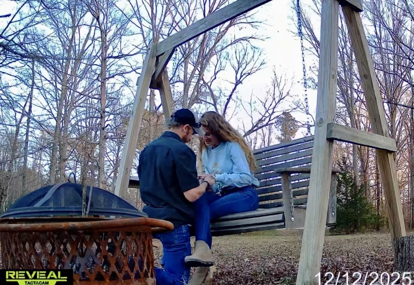 Trail camera photo of Jared proposing to Anna on a porch swing